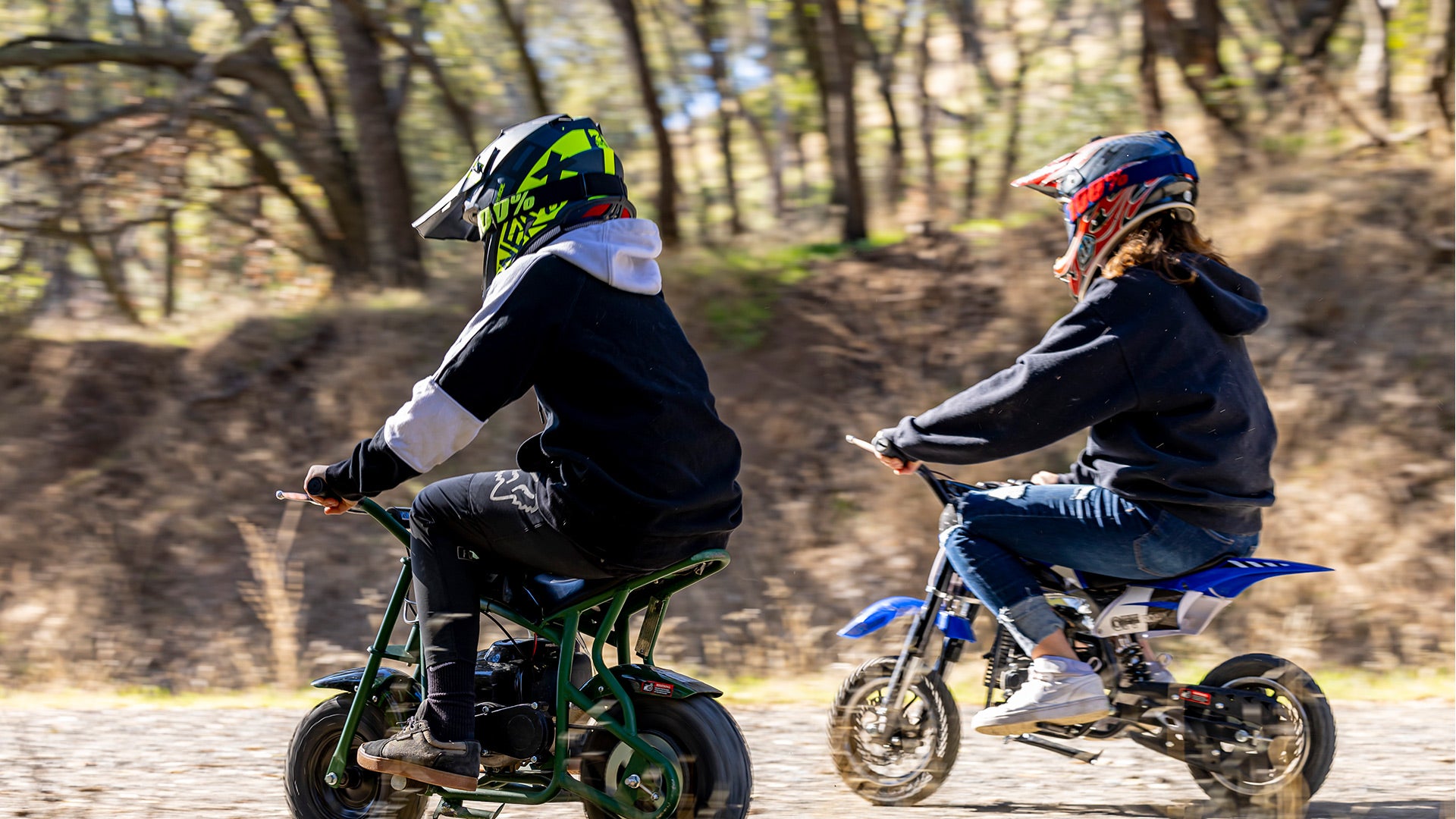 Two boys are riding mini bikes.