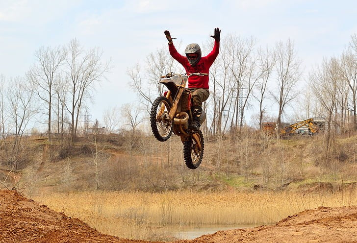 A man is riding a dirt bike.