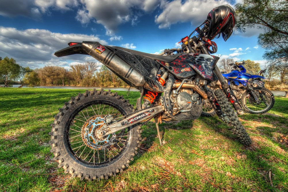 The dirt bikes on the grass land.