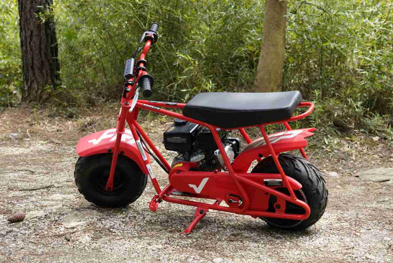 A Gas Mini Bike - FRP GMB100 is in the forest.