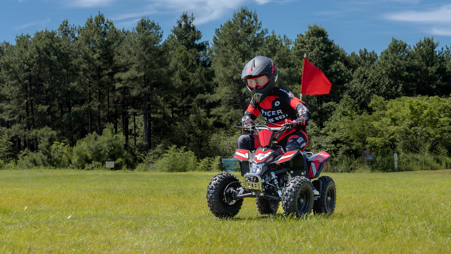 A kid is riding a kids ATV