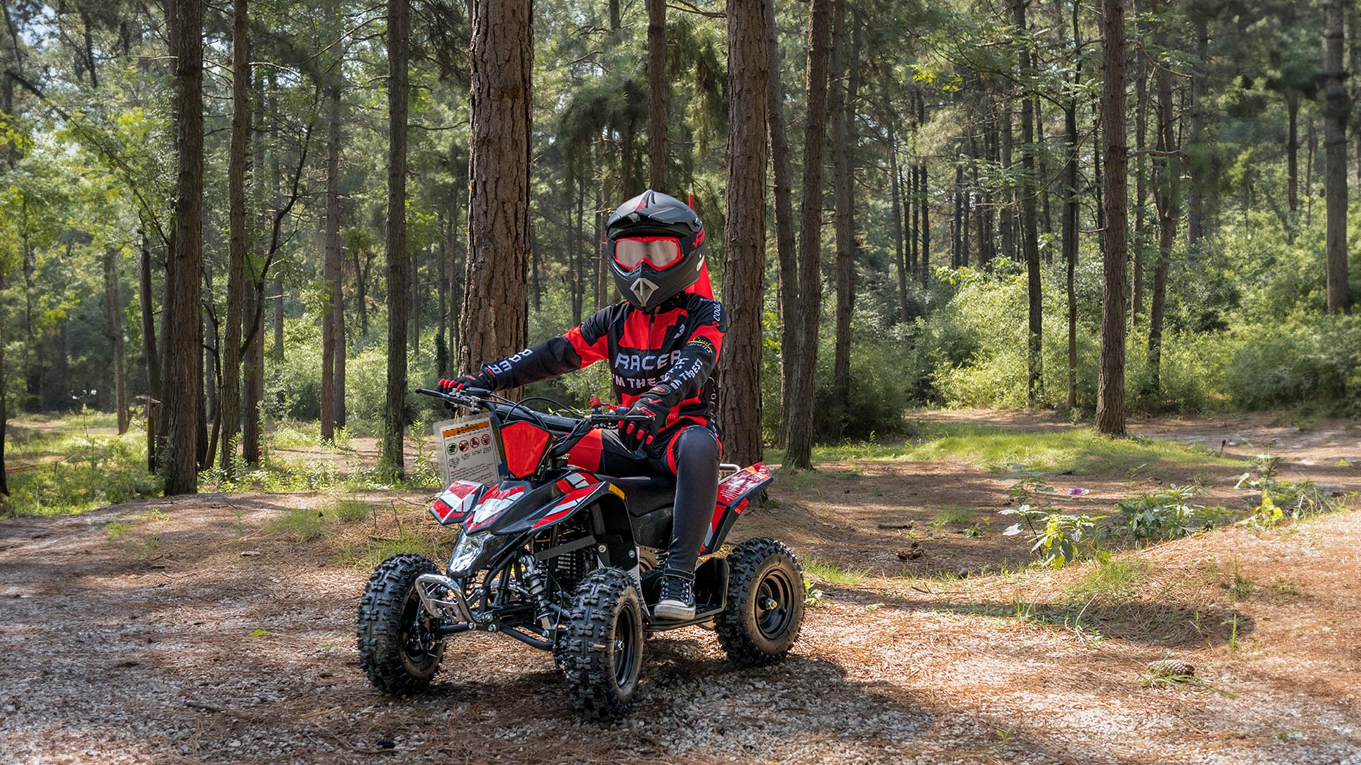 A kid is riding a Sahara 40 Gas Mini Quad.