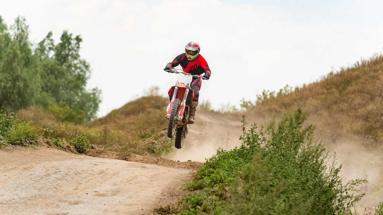 A man is riding a dirt bike on off road.